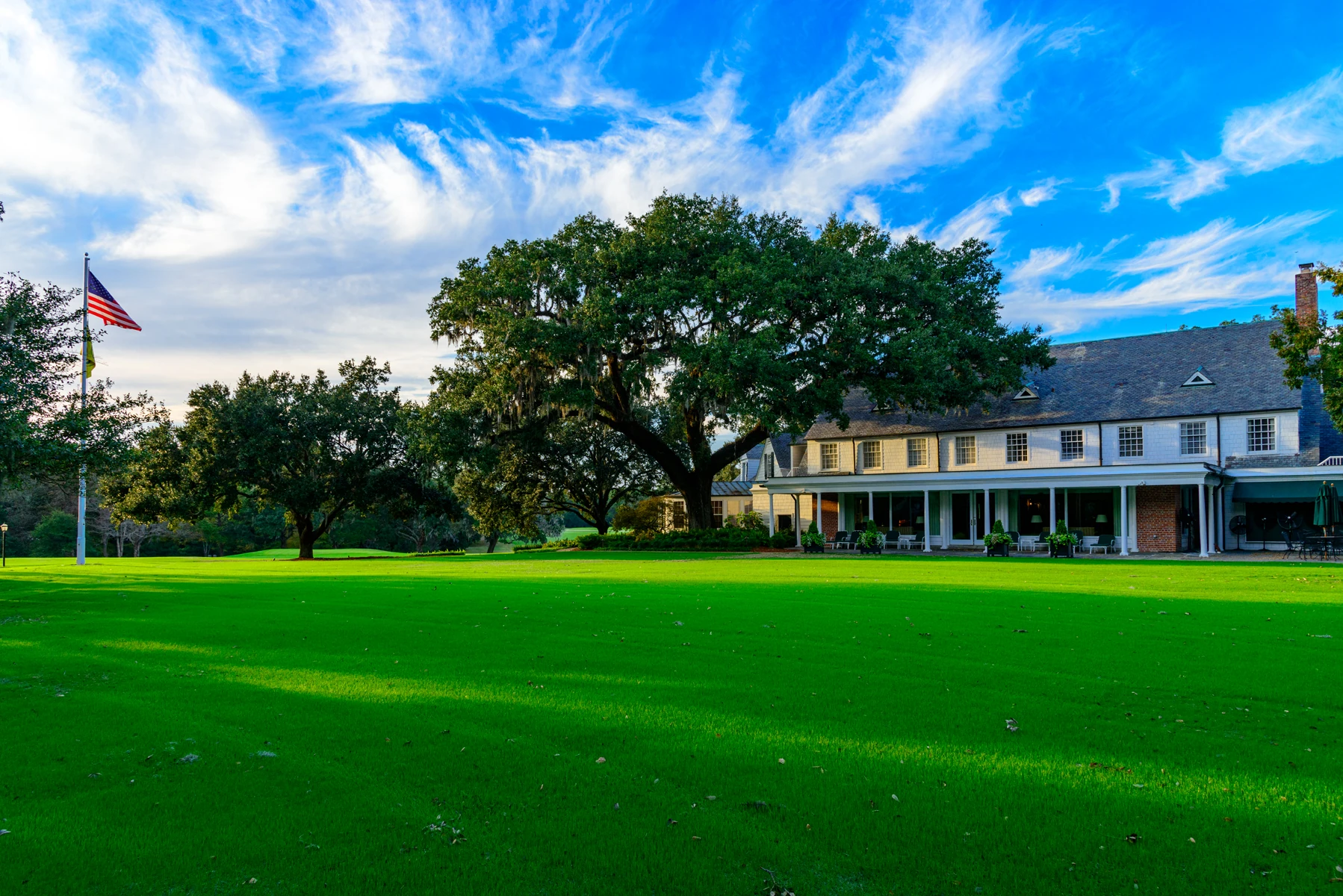 The Yeamans Hall clubhouse and its sweeping lawn beneath a Lowcountry live oak